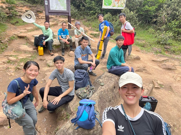 The research team is Hiking to the survey site